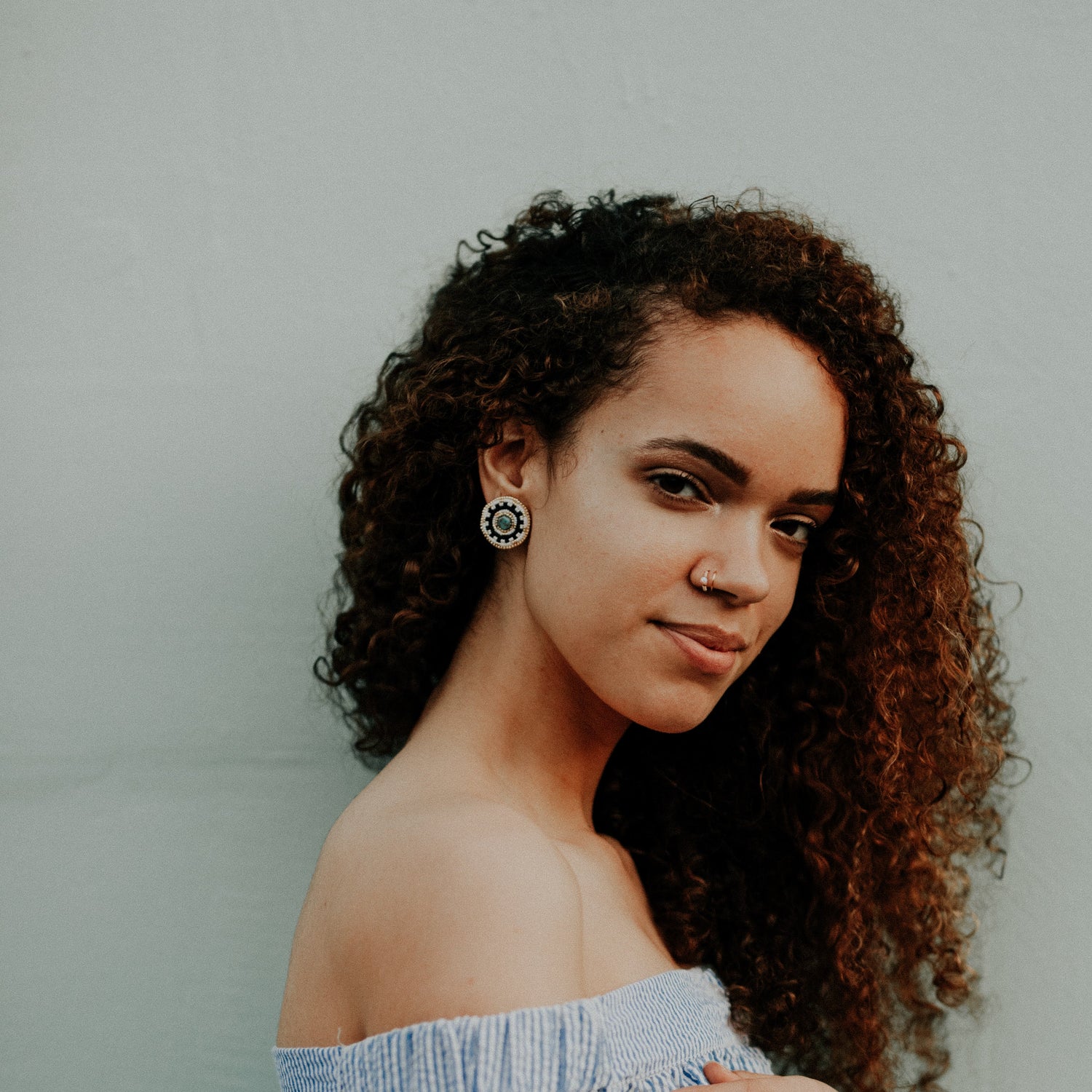 Model Wearing Cheyanne Symone’s Original Adeline Stud Beaded Earrings | White, Gold, Black Beads Around a Czech Glass Bead Center 