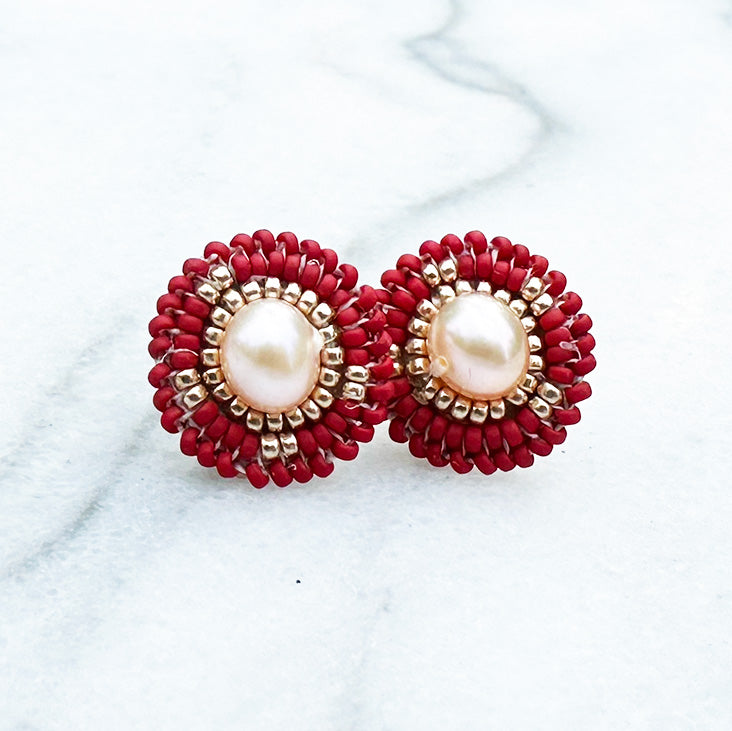 Direct front facing photo of Handcrafted Red Seed Bead Earrings on a marble background