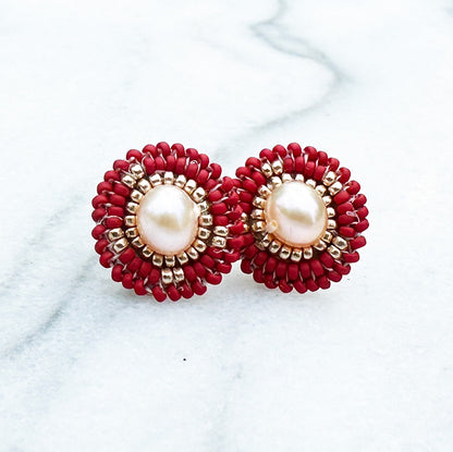 Direct front facing photo of Handcrafted Red Seed Bead Earrings on a marble background