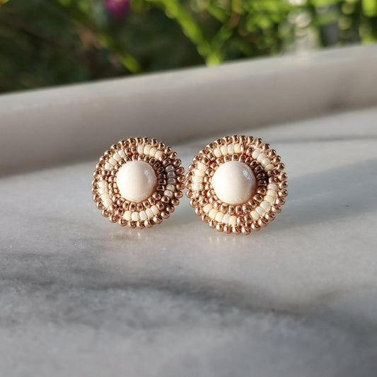 Cheyanne Symone's Ivory Glass Stud Earrings Sitting in a Marble Tray | Ivory and Gold Plated Glass Seed Beads Beaded Around a Round Glass Bead Center