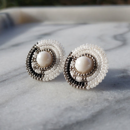 Cheyanne Symone’s Little Ash Earrings Sitting in a Marble Tray | Black and White Glass Seed Bead Earrings Featuring Metal Plated Beads Wrapped Around a Glass Bead Center